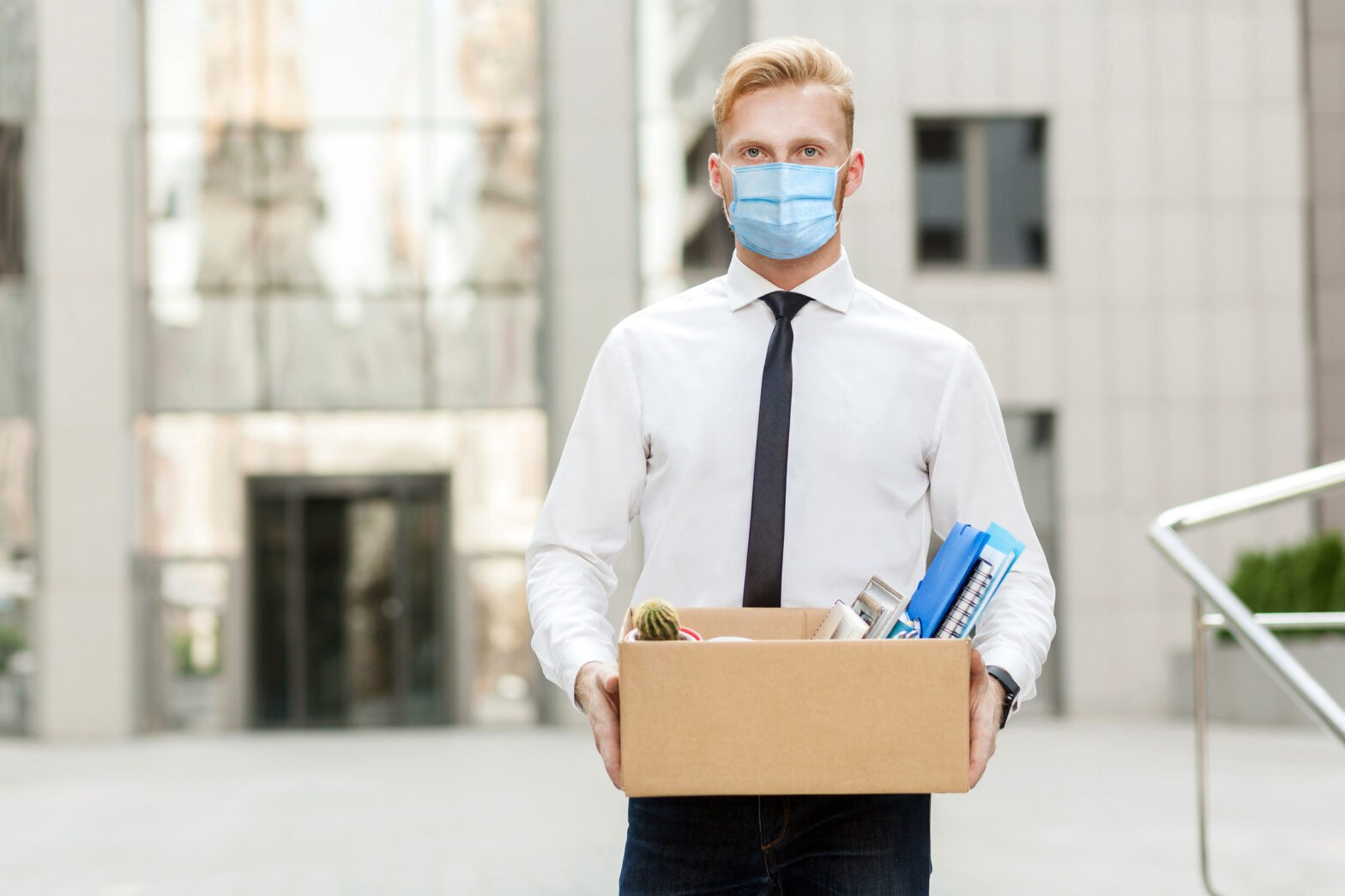 lose job, Youre fired. Unhappy business man with surgical medical mask going out with cardboard, looking at camera and feeling looser.